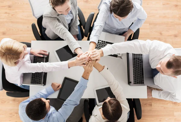 close up of business team with hands on top