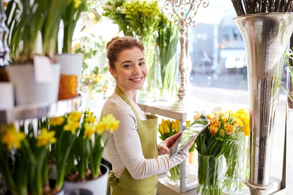 Kvinna med tablet pc-dator på blomsteraffär — Stockfoto