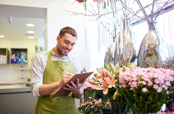 Florist man with clipboard at flower shop — Stock Photo, Image