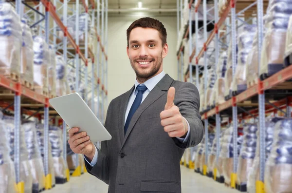 Businessman with tablet pc over warehouse — Stock Photo, Image
