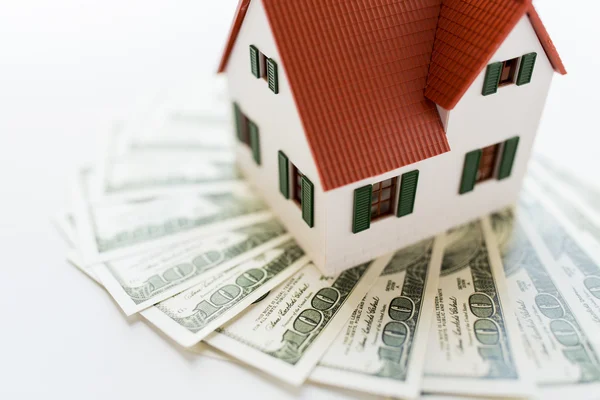 Close up of home or house model and money — Stock Photo, Image