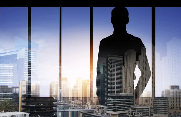 Silhouette of business man over city background — Stock Photo, Image