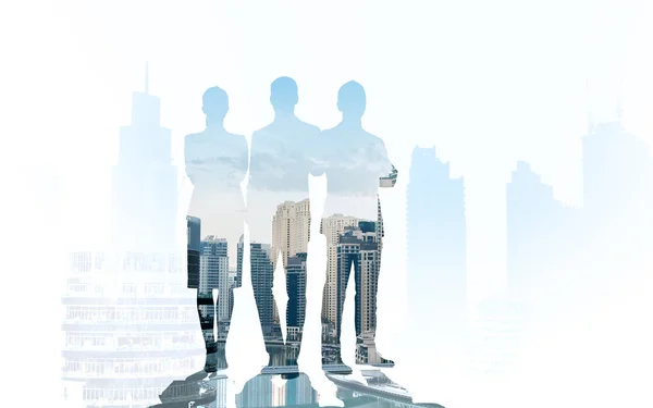 Business people silhouettes over city background — Stock Photo, Image