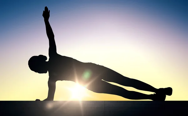 Woman doing plank exercise on stairs over sunlight — Zdjęcie stockowe