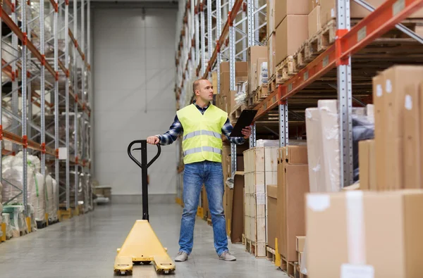 Man with loader and clipboard at warehouse — Stock Photo, Image