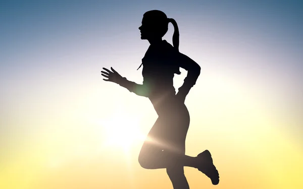 Happy young sports woman running outdoors Stock Image