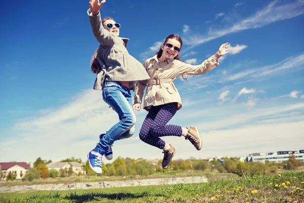 Happy little girls jumping high outdoors — Stock Photo, Image