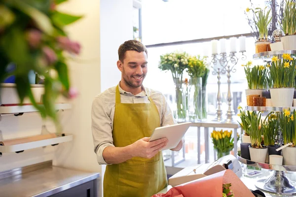 Man with tablet pc computer at flower shop — Stock Photo, Image