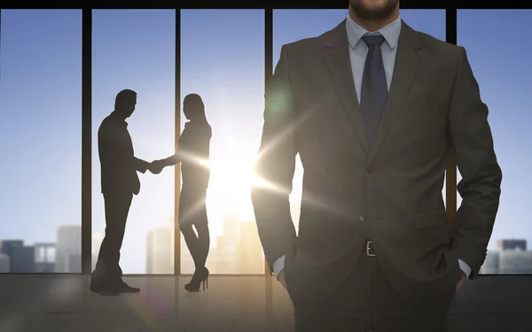 Business partners silhouettes shaking hands — Stock Photo, Image