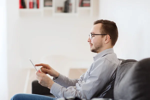 Uomo sorridente che lavora con tablet pc a casa — Foto Stock