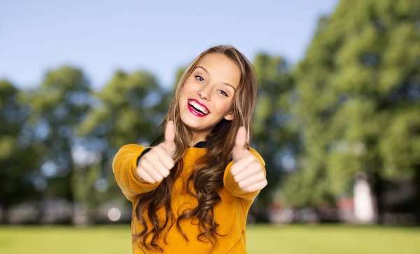 Счастливая молодая женщина или девочка-подросток, показывающая большие пальцы вверх Стоковая Картинка