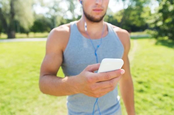 Close up of man with smartphone listening to music — Stock Photo, Image