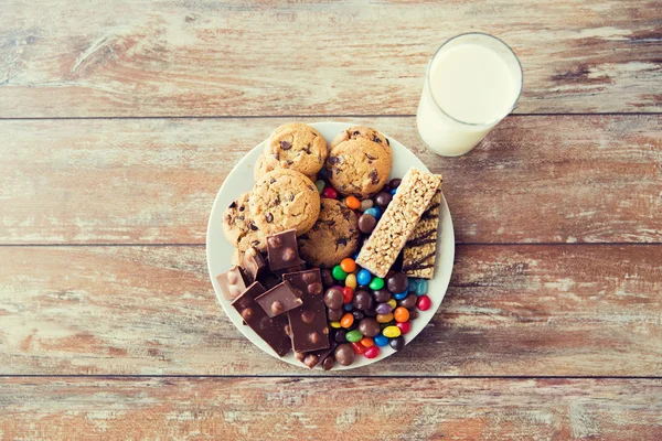 Close up of sweet food and milk glass on table — ストック写真