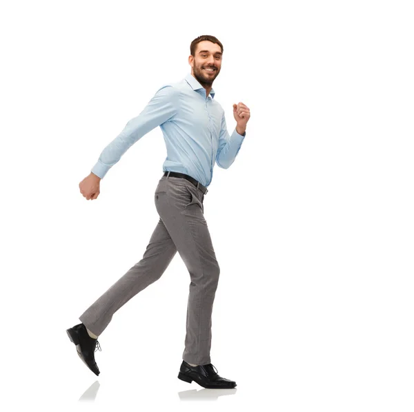 Smiling young man running away — Stock Photo, Image