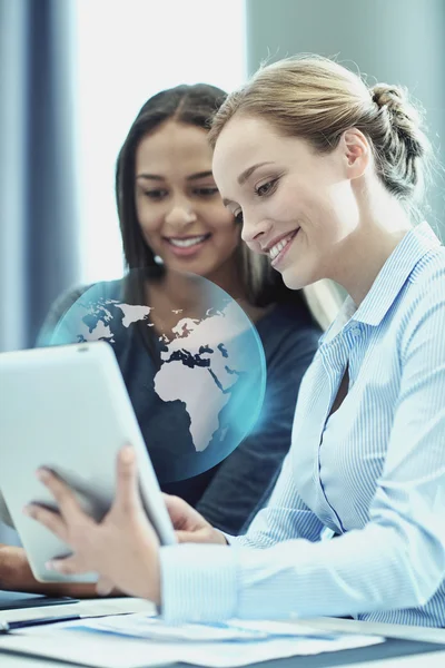 Smiling businesswomen with tablet pc in office — Stock Photo, Image