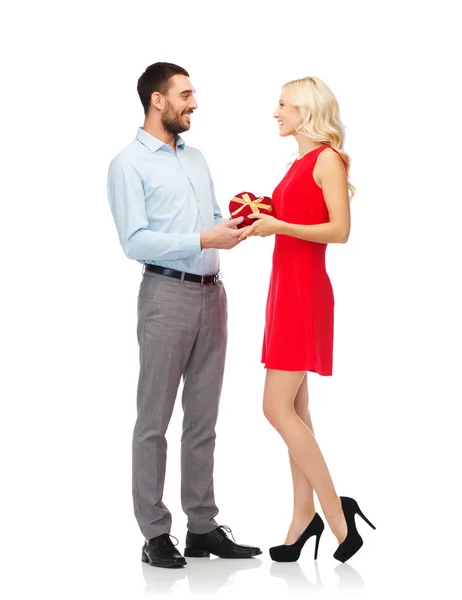 Happy couple with red heart shaped gift box — Stock Photo, Image