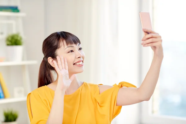 Счастливая азиатка делает селфи со смартфоном — стоковое фото