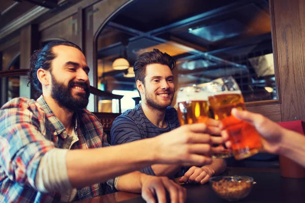 Amigos varones felices bebiendo cerveza en el bar o pub —  Fotos de Stock