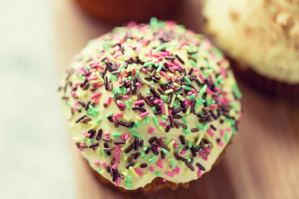 Close up of glazed cupcake or muffin on table — Stock Photo, Image