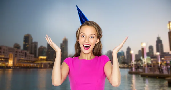 Happy young woman or teen girl in party cap — Stock Photo, Image