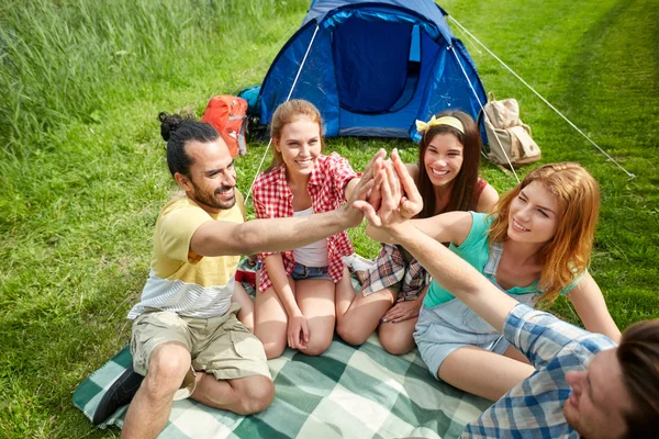 Happy friends making high five at camping — Stock Photo, Image