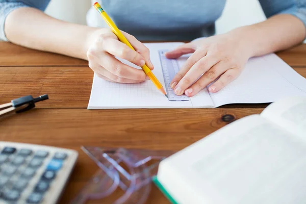 Close up of hands with ruler and pencil drawing — Stock Photo, Image