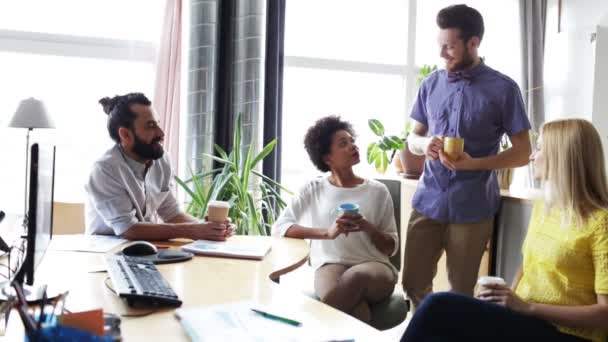 Happy creative team drinking coffee in office — Stock Video