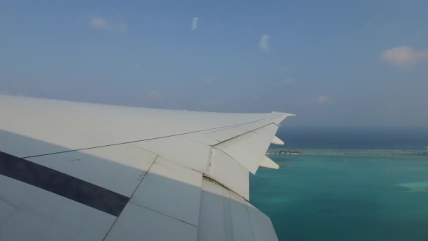 Wing of airplane flying above ocean — Stock Video