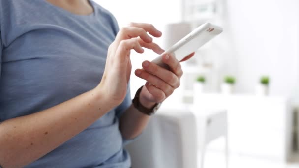 Woman hands texting message on smartphone at home — Stock Video