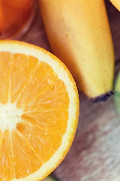 Close up of fresh juicy orange and banana on table — Stock Photo, Image