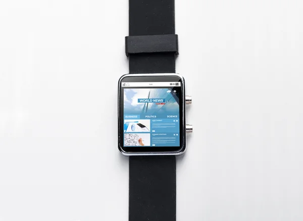 Close up of black smart watch with world news page — Stock Photo, Image