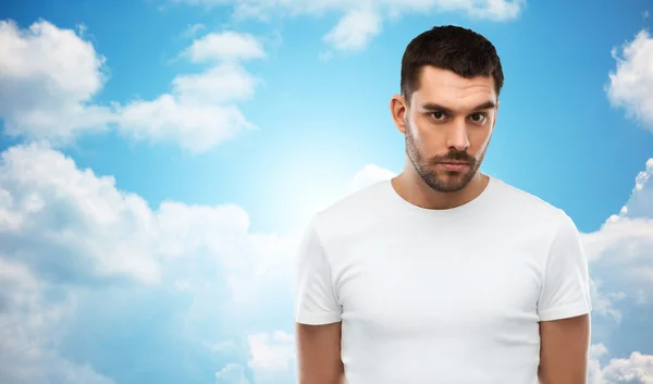 Young man portrait over sky and clouds background — Stok fotoğraf