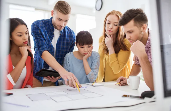 Creative team with blueprint working at office — Stock Photo, Image