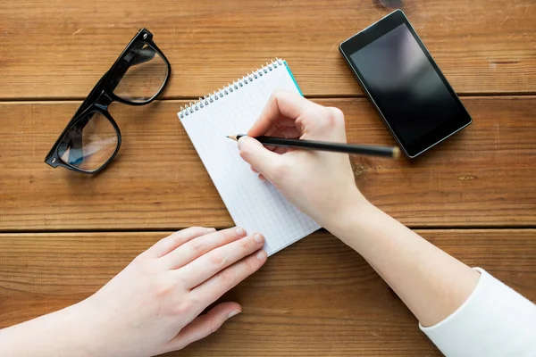 Close up of woman or student writing to notepad — Stock Photo, Image