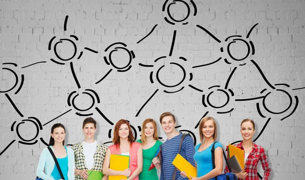 Group of teenage students with folders and bags — Stock Photo, Image