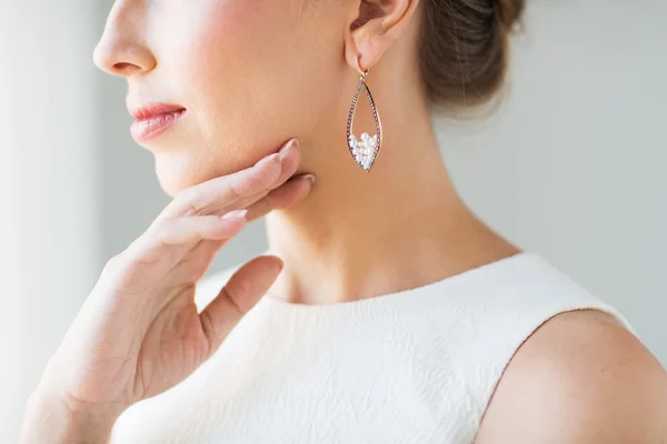 Close up of beautiful woman face with earring — Stock Photo, Image