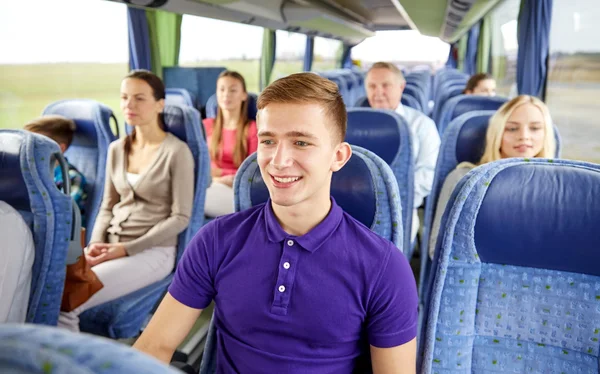 Happy young man sitting in travel bus or train — Stock Photo, Image