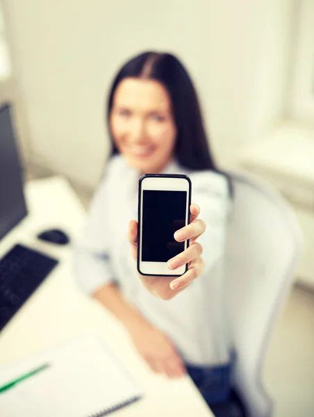 Close up of woman showing smartphone at office — Stock Photo, Image