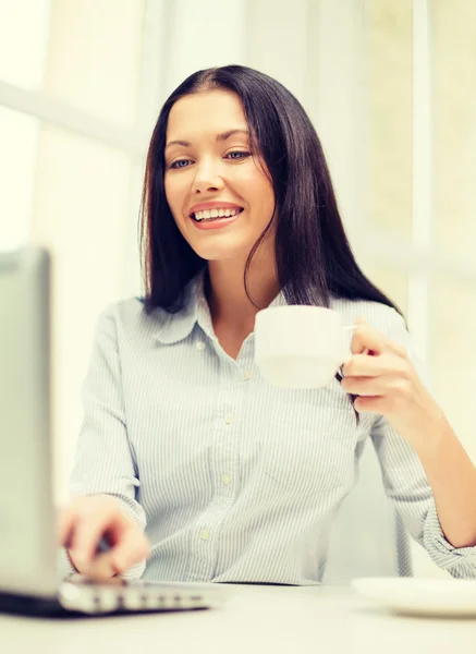 Smiling businesswoman or student with laptop — Stock Photo, Image