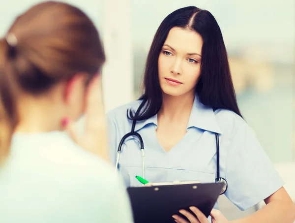 Vrouwelijke arts of verpleegkundige met patiënt — Stockfoto