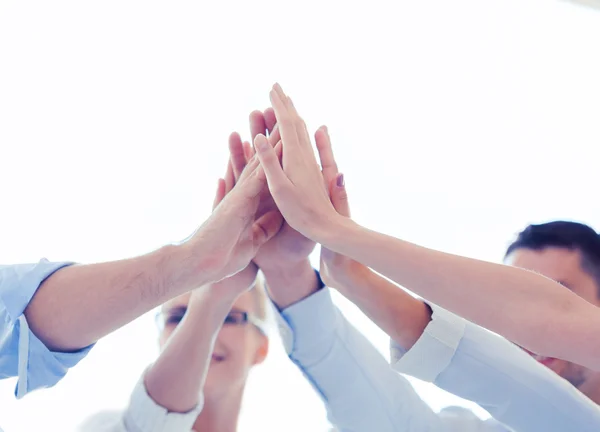 Happy business team giving high five in office — Stock Photo, Image