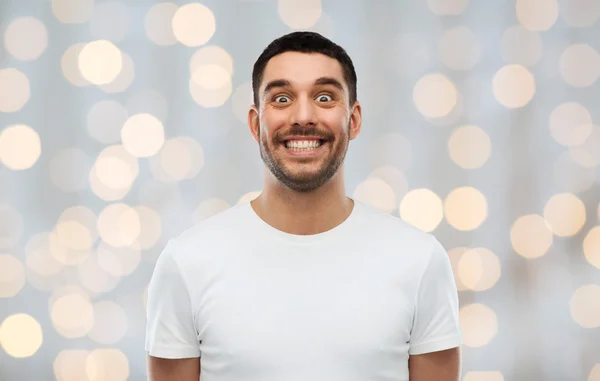 Man with funny face over lights background — Stock Photo, Image