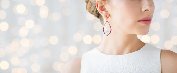 Close up of beautiful woman face with earring — Stock Photo, Image