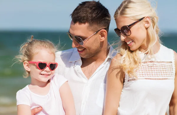 Happy family in sunglasses on summer beach — Stock Photo, Image