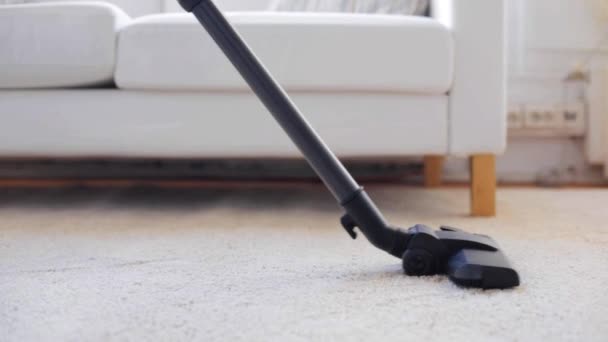 Woman with vacuum cleaner cleaning carpet at home — Stock Video