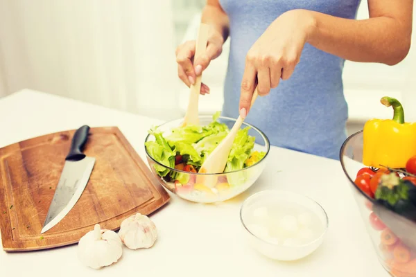 Close up of woman cooking vegetable salad at home — Stock Photo, Image