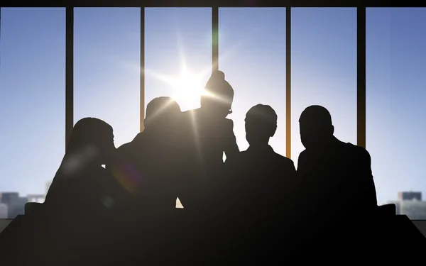 Business people silhouettes over office background — Stock Photo, Image