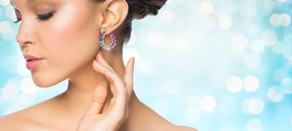 Close up of beautiful woman face with earring — Stock Photo, Image