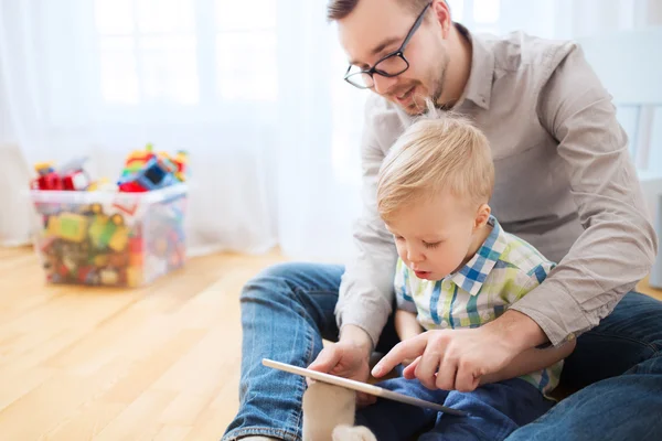 Far och son med tablet pc spelar hemma — Stockfoto