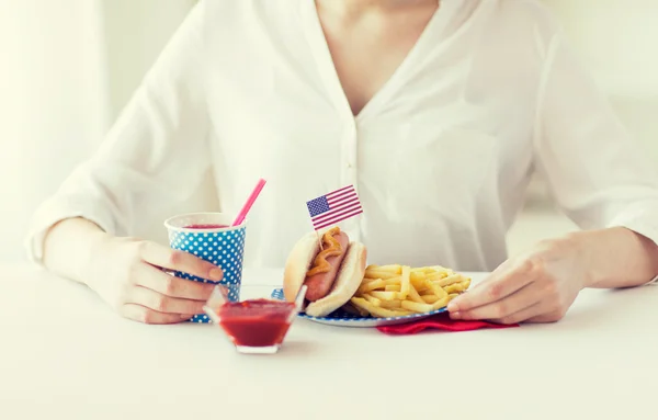 Close up of woman eating hotdog and french fries — Stock Photo, Image